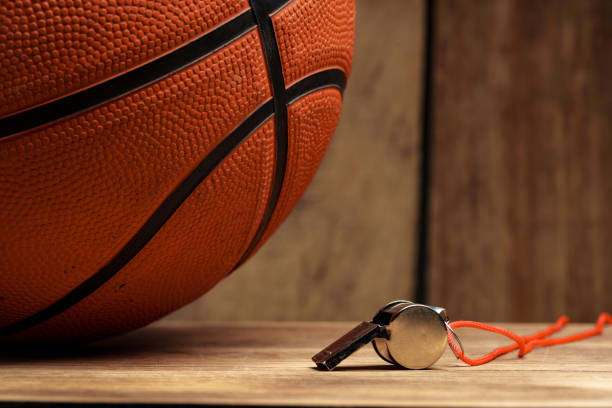 Basketball ball lying on a wooden floor close up