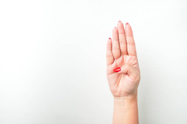 A woman's hand with bright red nail polish is making a raising four fingers gesture. Index, middle, Ring and little finger raise. Isolated on white background - Cut Out