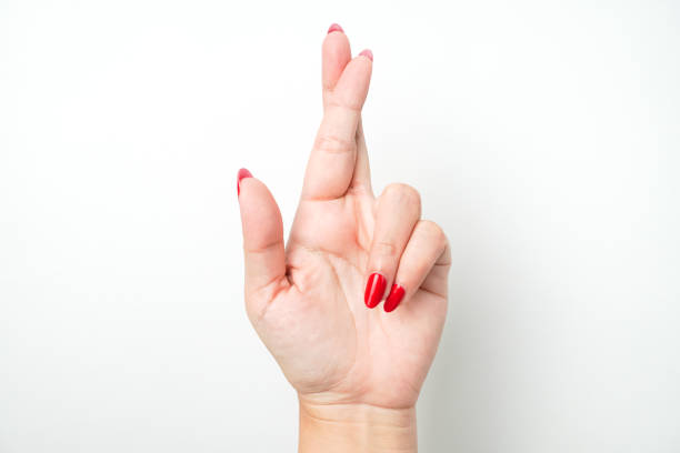 Two hands are playing thumb wrestle in front of white background.