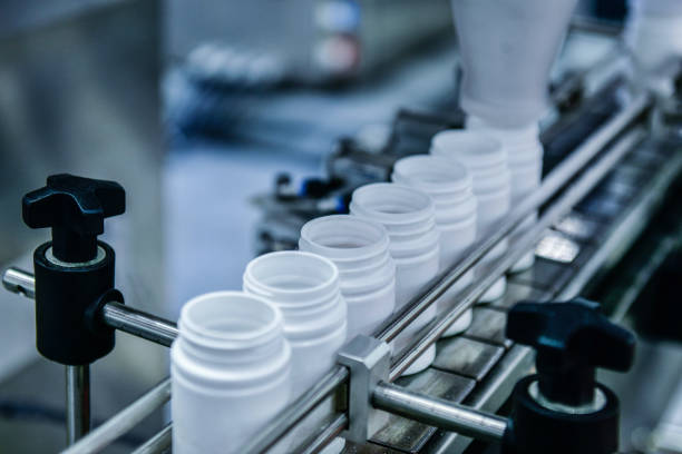 istock High speed counting and automatic tablet bottling machine in the pharmaceutical industry production line 2158057809