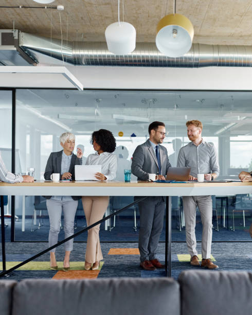 istock Group of entrepreneurs working on reports and laptop in a modern office. 2158057926