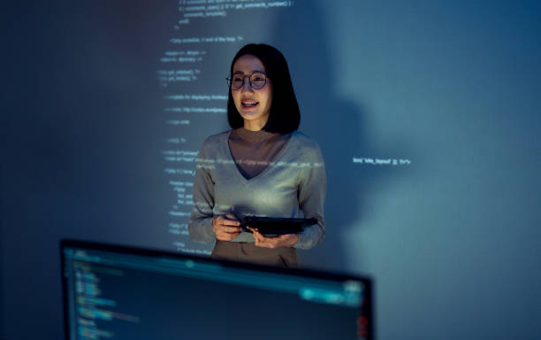 istock asian woman programmer standing in front of a screen with code projected  presentation the integration of technology and human expertise in software development 2158058781