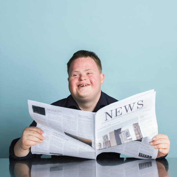 istock Boy with down syndrome reading a newspaper during the coronavirus pandemic 2158058962