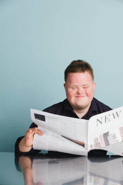 istock Boy with down syndrome reading a newspaper during the coronavirus pandemic 2158058967