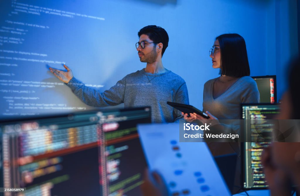 Asian Developer Leads Present Code Review Session Pointing At Code ...