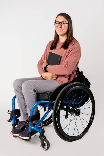 istock Cool woman in a wheelchair with a black book 2158059087