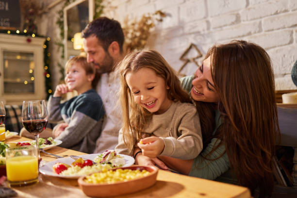 istock Happy family enjoying during lunch in dining room. 2158059582