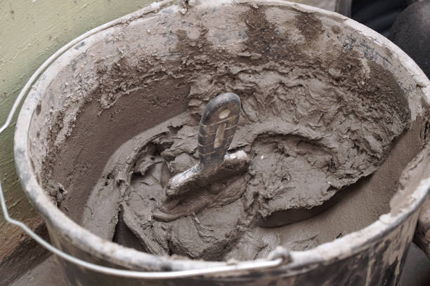 istock Plaster or cement in a bucket with spatula or trowel 2158059743