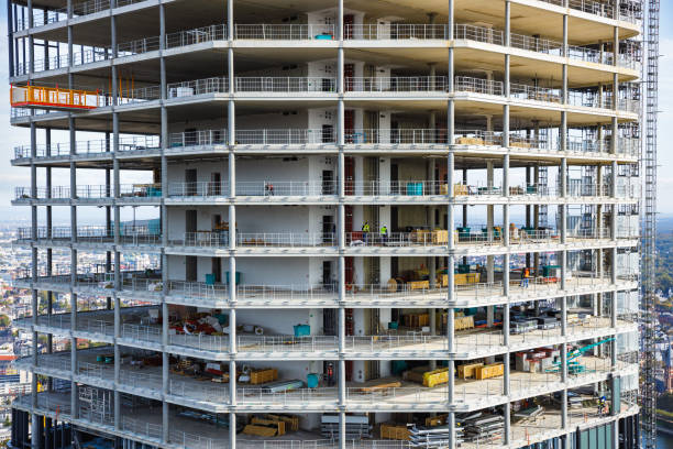 Cranes on a building under construction in a large city. Concept: construction and housing