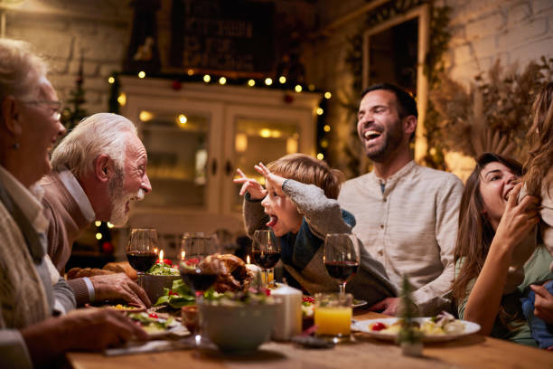 istock Happy extended family having fun during lunch in dining room. 2158059781