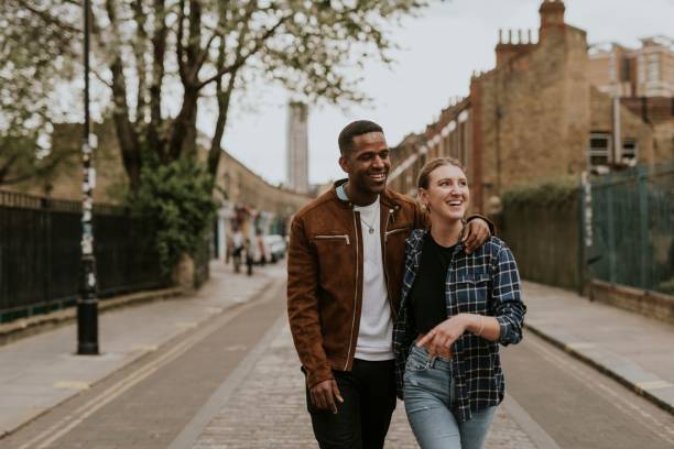 Diverse couple on a date, walking in the city