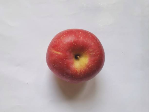Red apple on red background