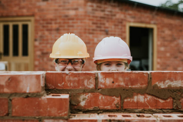 istock Playful mother and daughter bricklaying 2158061905