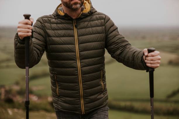 istock Man wearing jacket, holding hiking pole 2158061992