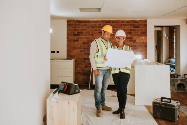 istock Contractor coworkers working together on remodeling home 2158062015