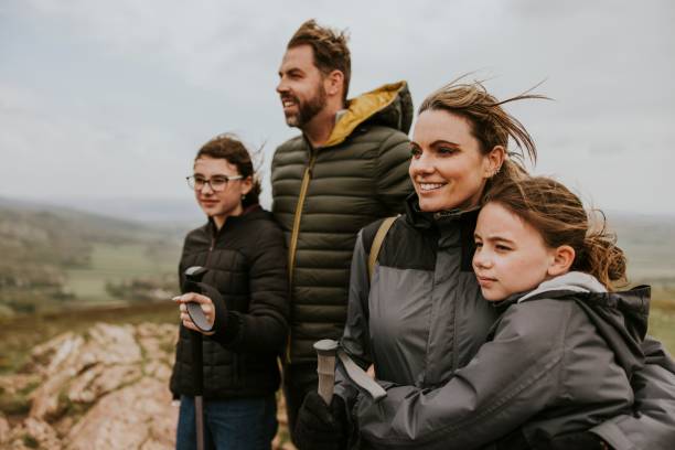 istock Family standing on mountain, outdoor activity 2158062089