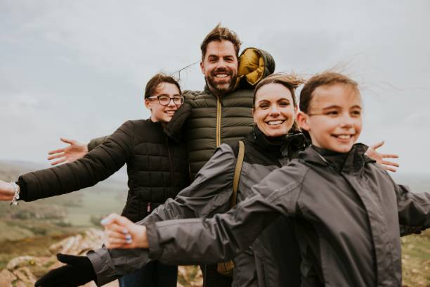 istock Happy family standing on mountain, outdoor activity 2158062101
