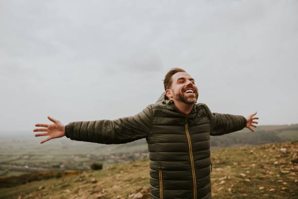 istock Happy man spreading arms on mountain 2158062160