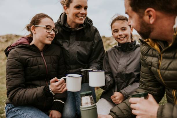 Camping family having morning drinks