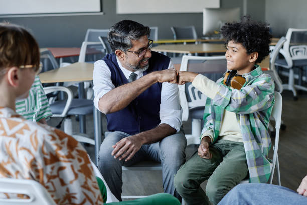 istock Teacher And Student Doing Fist Bump 2158062329