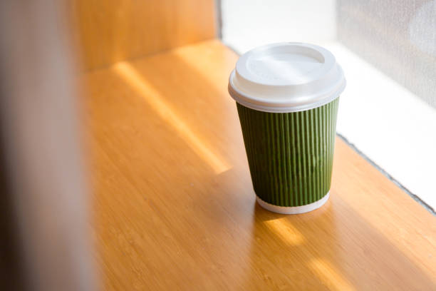 Cup of coffee to go at early morning in hotel room