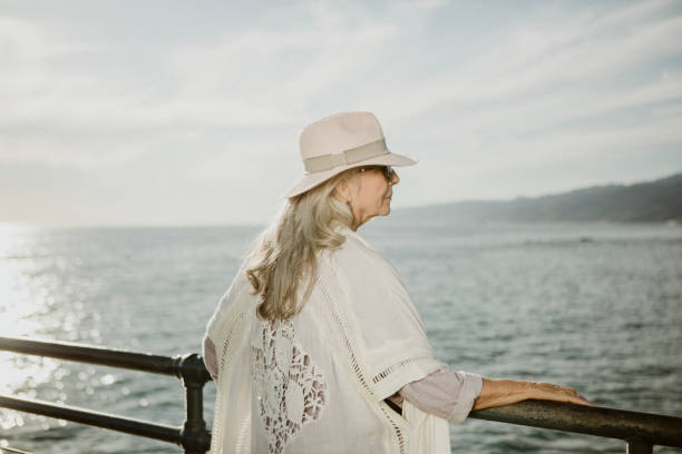 istock Senior woman standing by the pier 2158066055