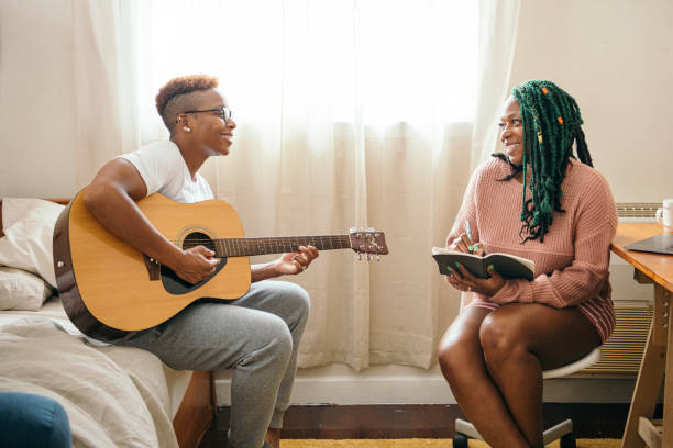 istock Happy lesbian couple making music together 2158069507