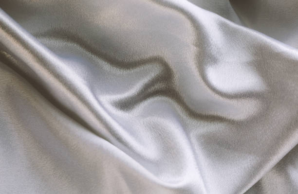 istock delicate wedding background made of satin fabric with soft waves 2158070398