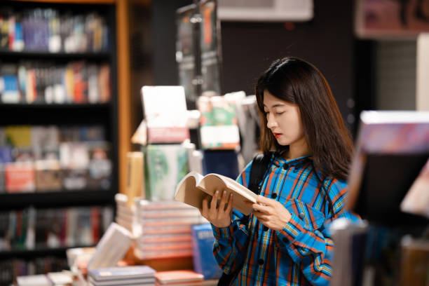 istock University  student buying books in bookstore at night 2158071376