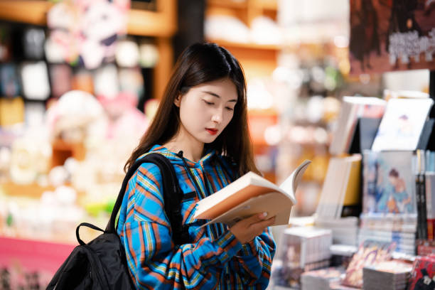 istock University  student buying books in bookstore at night 2158071398