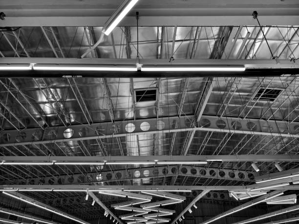 Ceiling with pipes is beautifully decorated with many industrial lamps.