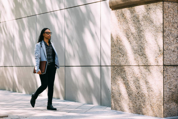 istock Businesswoman Walking Outside Office Building Holding Notebook 2158071795