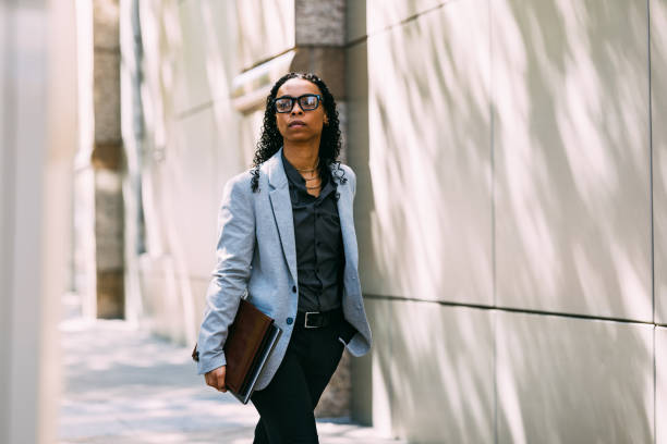 istock Confident Business Professional Walking Outside Modern Building 2158071800