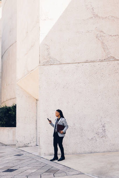 istock Business Professional Using Smartphone Outside Modern Building 2158071846