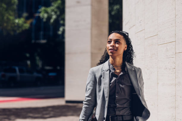 istock Confident Businesswoman Walking Outdoors in Sunny Urban Setting 2158071859