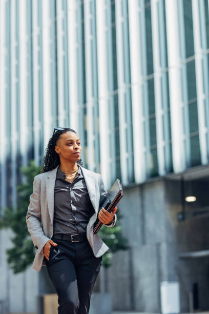 istock Confident Businesswoman Walking Outside Office Building 2158071876