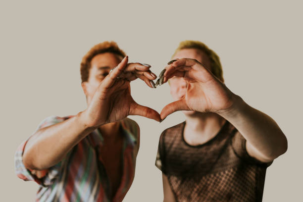 Gay couple making heart shaped-hands, gender equality