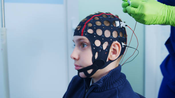 istock Doctor weares  Electrode Cap on Boy for EEG Test in Clinic 2158072228