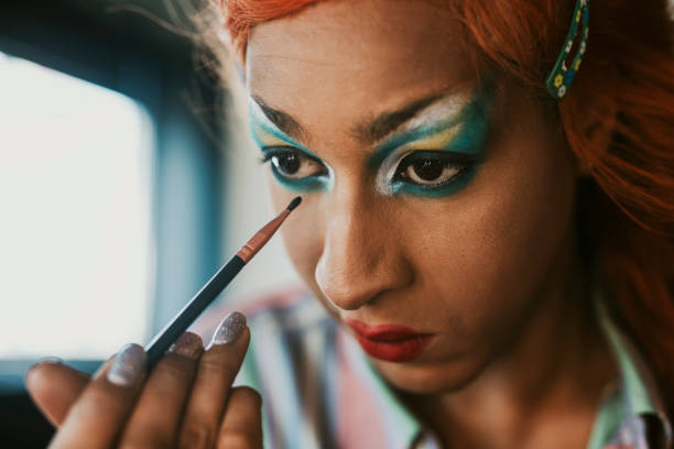 istock Man in drag applying eyeshadow, entertainment makeup look 2158072265
