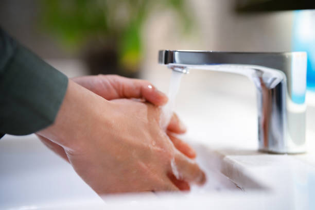 istock An adult man is washing his hands 2158072344