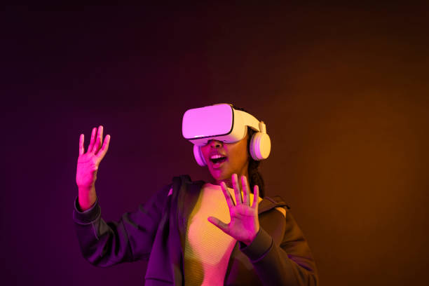 istock African American woman using virtual reality gadget for entertainment 2158074911