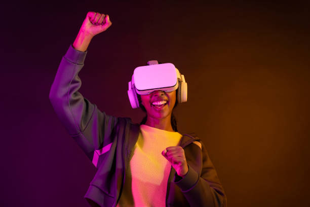 istock African American woman using virtual reality gadget for entertainment 2158075140