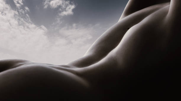 istock Monolithic Forms. Majestic curves of human body forming mountain ranges under a vast sky. Aesthetic pleasure from body and nature. 2158076432