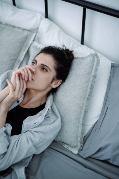 istock Disappointed brunette woman lying on bed at home, mental problem concept 2158077390