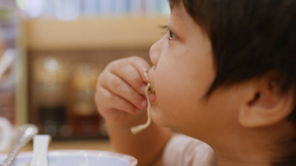 istock Happy Asian boy enjoy eating ramen. 2158077577