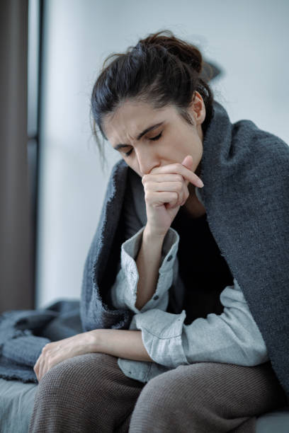 istock Depressed woman in blanket feeling sorrow while sitting on bed at home 2158078626
