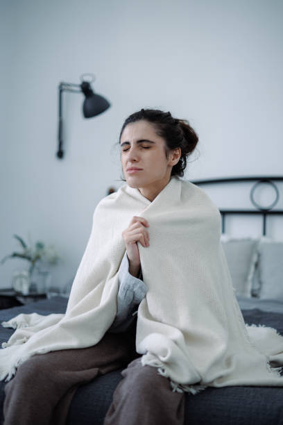 istock Distressed woman holding blanket while feeling emotional crisis on bed at home 2158078630