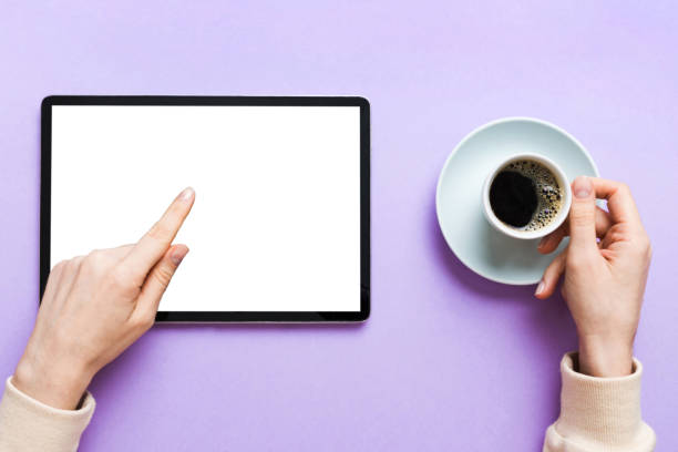 istock Close up image woman hands holding digital tablet with blank copy space screen for your text message or promotional content om table with cup of coffee. hands of a woman holding blank tablet device 2158079503