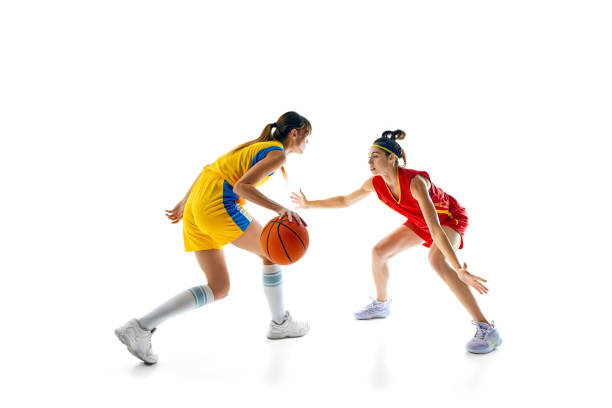 istock Two female basketball players in a dynamic one-on-one pose playing, competing for victory isolated on white studio background 2158080104