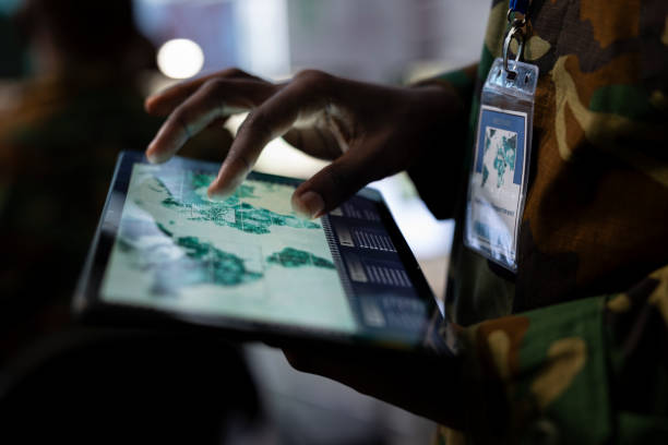 istock Army IT professional monitors satellite world map to search for enemy vessels 2158081476